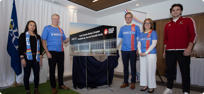 Men and women revealing the plans for the Fortis Canada Games Complex