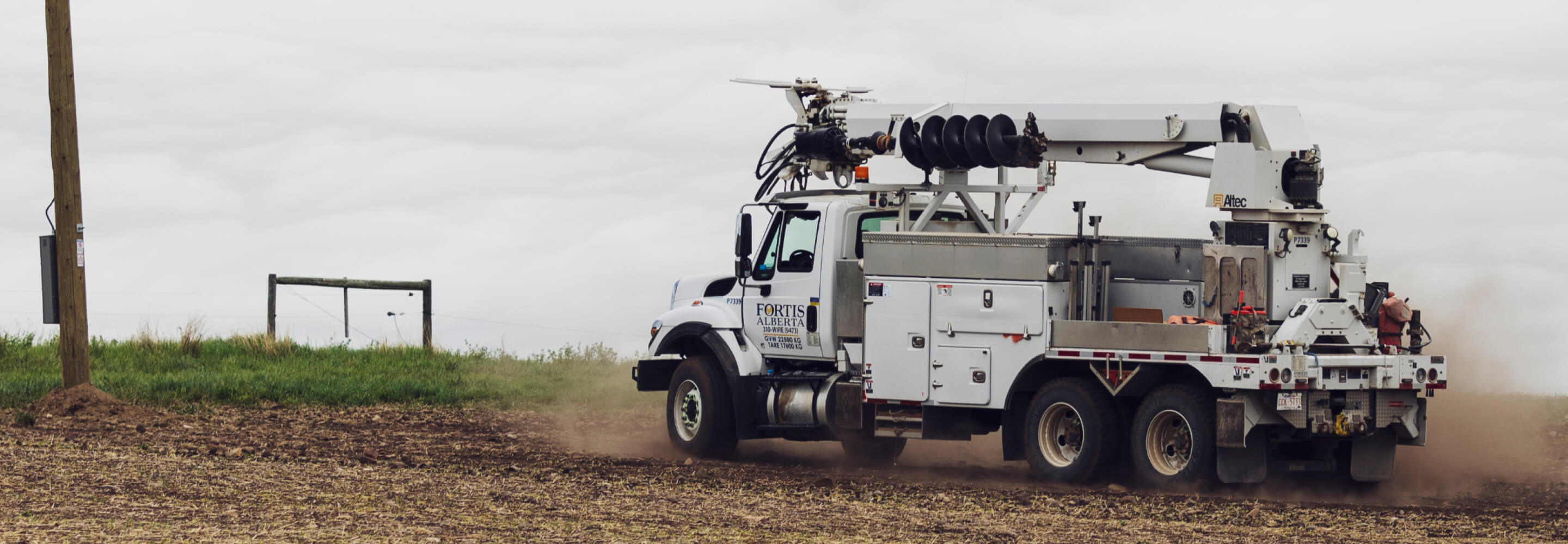 Bucket truck driving towards power lines