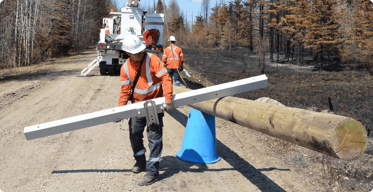 Employee working on restoring power lines