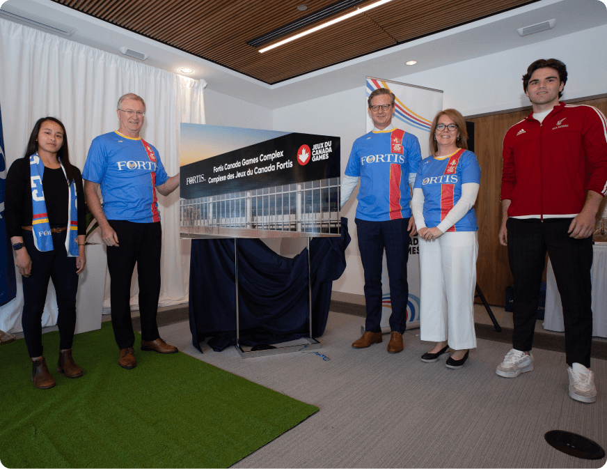 Men and women revealing the plans for the Fortis Canada Games Complex