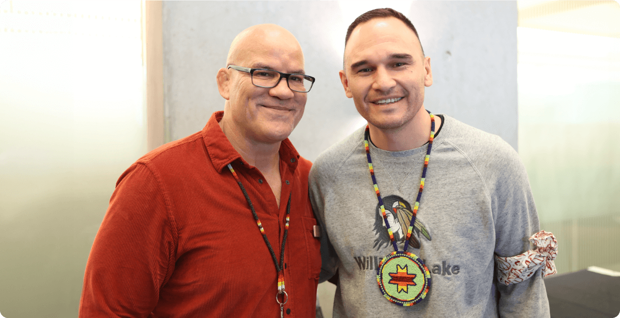 Two men standing together and smiling