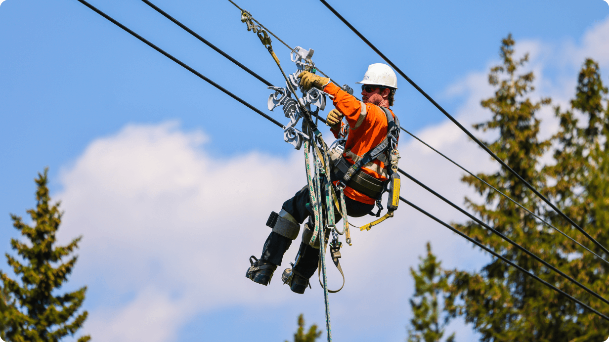 Employee working on power lines in safety gear